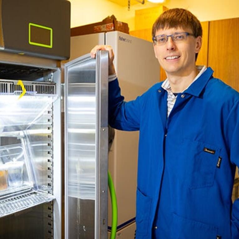 Robert Jinkerson with mushroom cultures (UCR/Stan Lim)