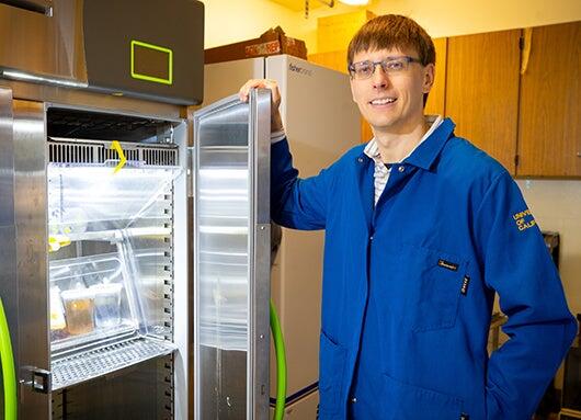 Robert Jinkerson with mushroom cultures (UCR/Stan Lim)